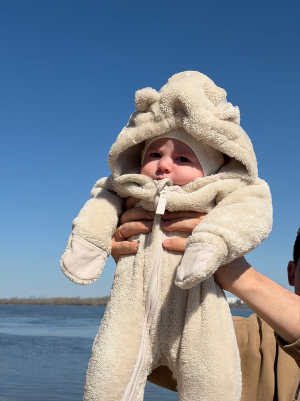 Friends enjoy sunny spring day by water in Noviy