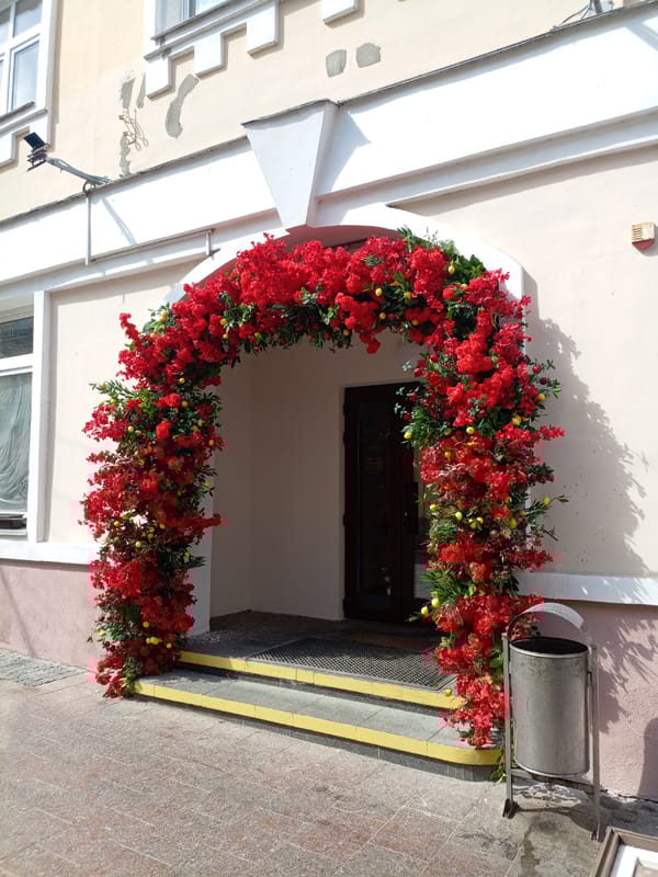 Floral archway decorates building entrance in Hrodna, Belarus