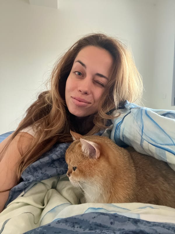 Woman shares morning moment with cat in Montenegro bedroom