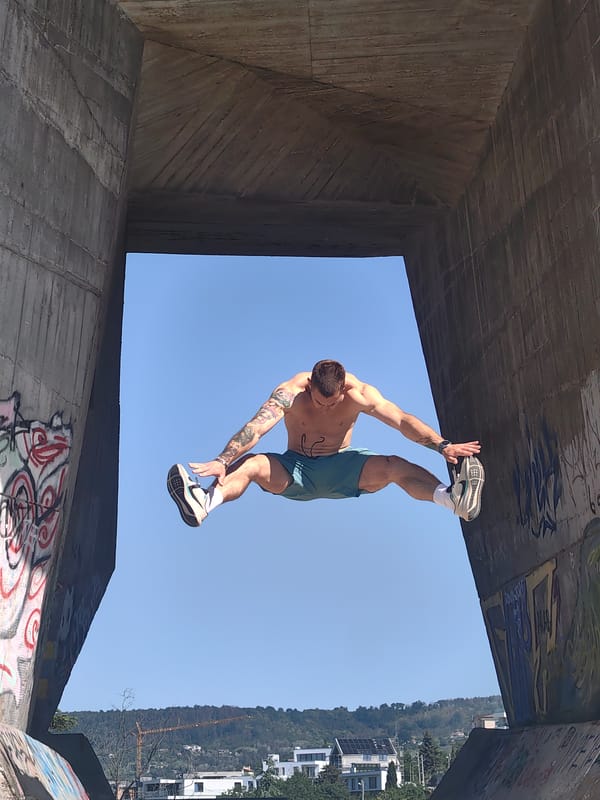 Acrobat performs stunts at graffitied concrete structure in Varna