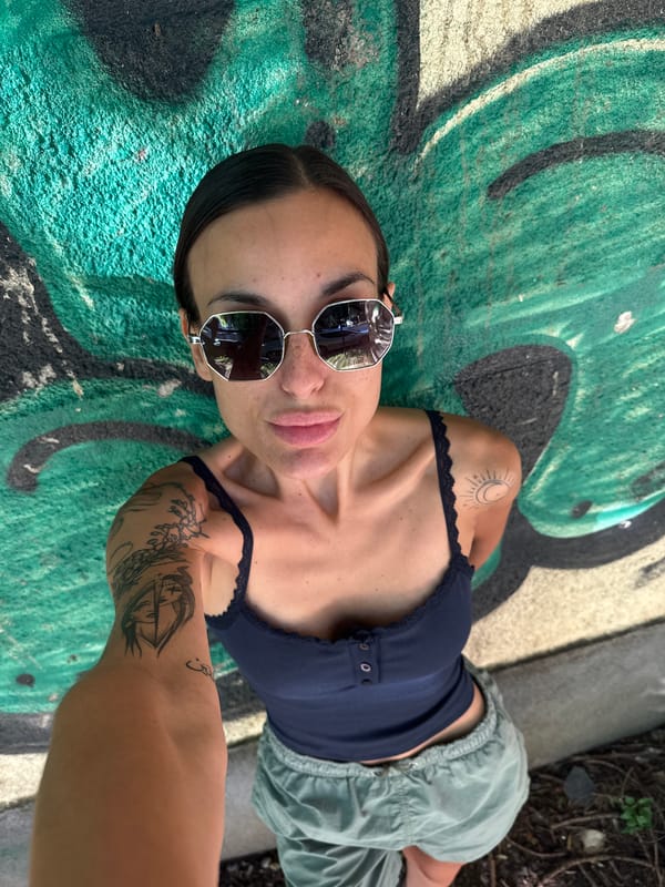 Woman photographed on graffiti surface in Pleven, Bulgaria