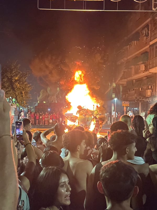 Alicante's Hogueras bonfire lights up the street at midnight