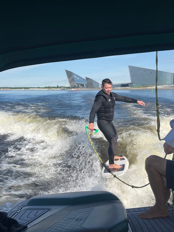 Wake surfing behind a boat on the Neva River