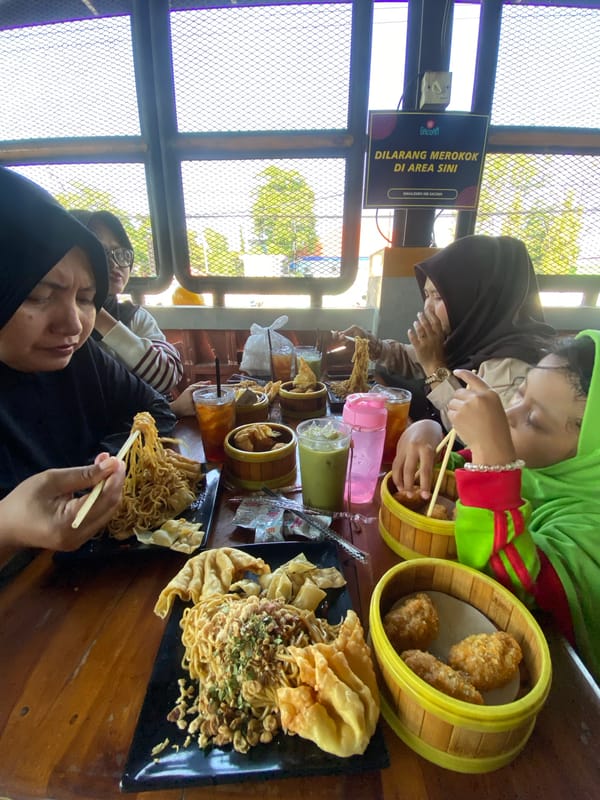 Family shares noodle meal at Indonesian restaurant in Candi
