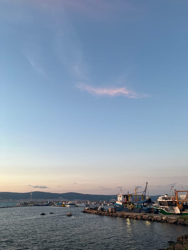 Sunset over Nesebar's Black Sea waterfront, promenade busy at dusk