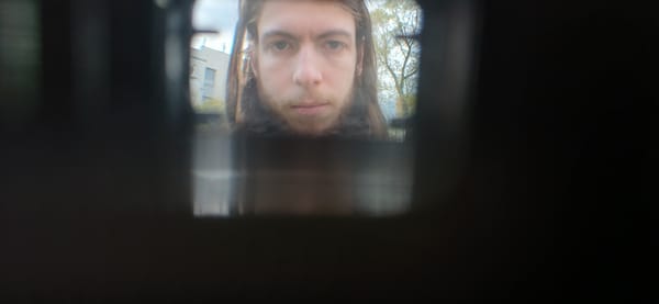 Person observed through peephole in urban setting