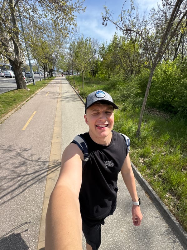 Young man takes playful selfies near red Porsche in Plovdiv