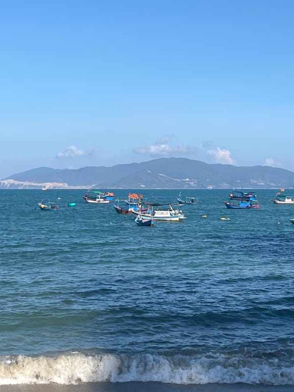 Fishing boats dot turquoise waters off Nha Trang coast
