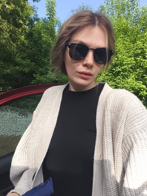 Woman photographed with red car in rural Izhevsk