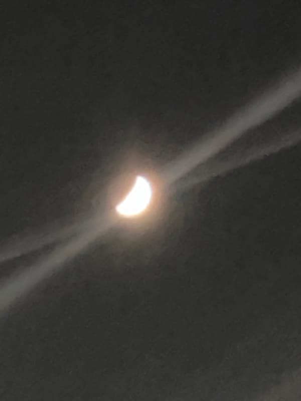 Crescent celestial object observed during apparent partial eclipse event