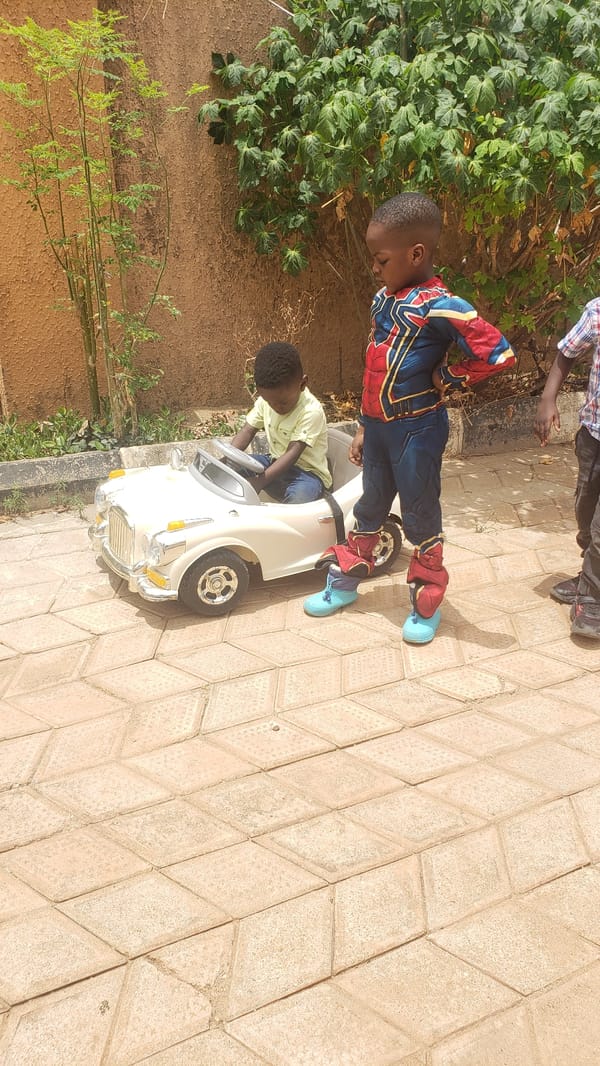Boys play with toy car in Sabon Tasha
