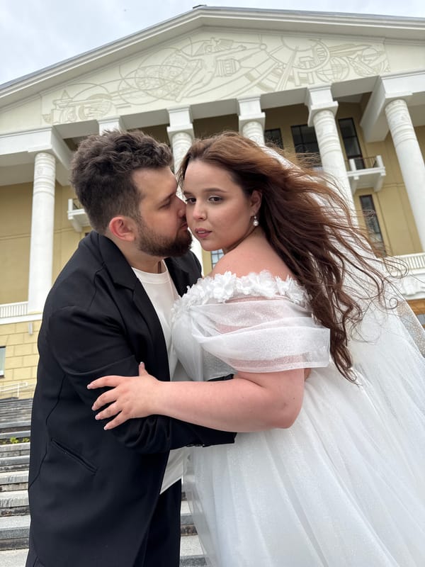 Wedding portraits on a classical building's steps in Votkinsk