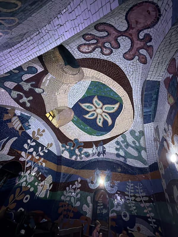 Visitor documents mosaic art and garden paths in Tbilisi
