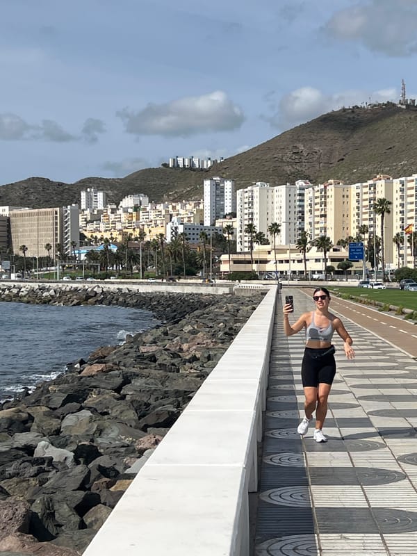 Woman takes selfies along Las Palmas waterfront walkway
