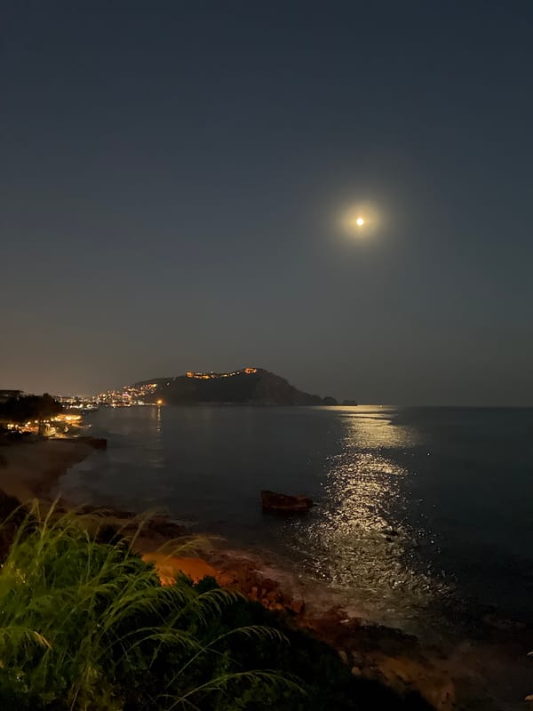 Full moon rising over the Alanya coastline at dusk