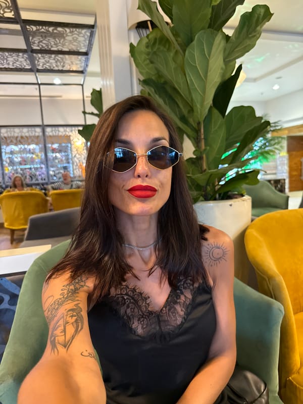 Selfie moment in an Aksu hotel lounge, sunglasses and red lips