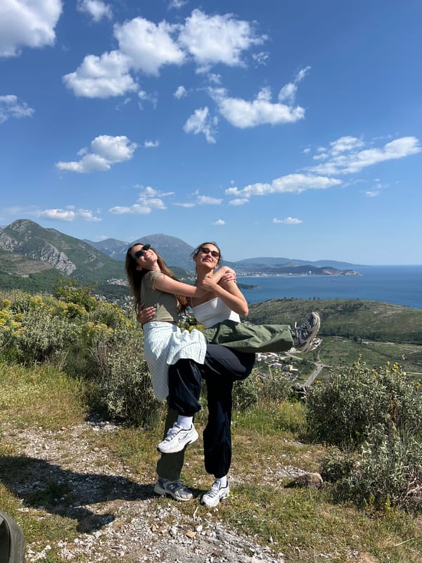 Women photograph scenic coastal visit in Sutomore, Montenegro