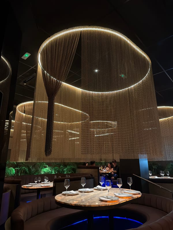 Inside an upscale Almería restaurant with chain-link curtain decor