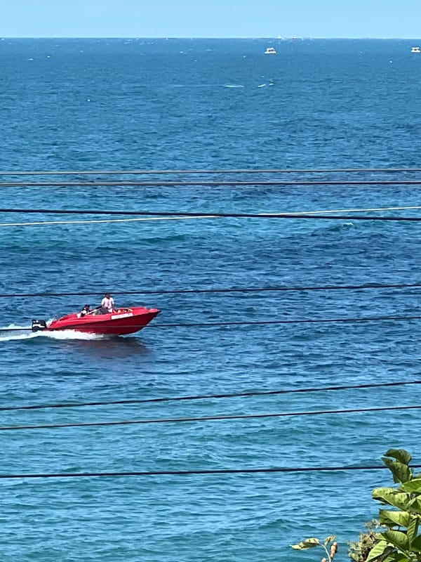 Red speedboat racing through choppy Black Sea waters near Sochi