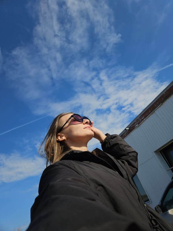 Woman photographed outdoors under blue skies in Chaikovsky, Russia