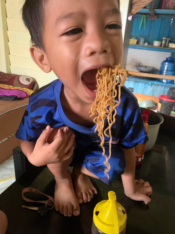 Late-night noodle meal in Sungai Meriam, Indonesia