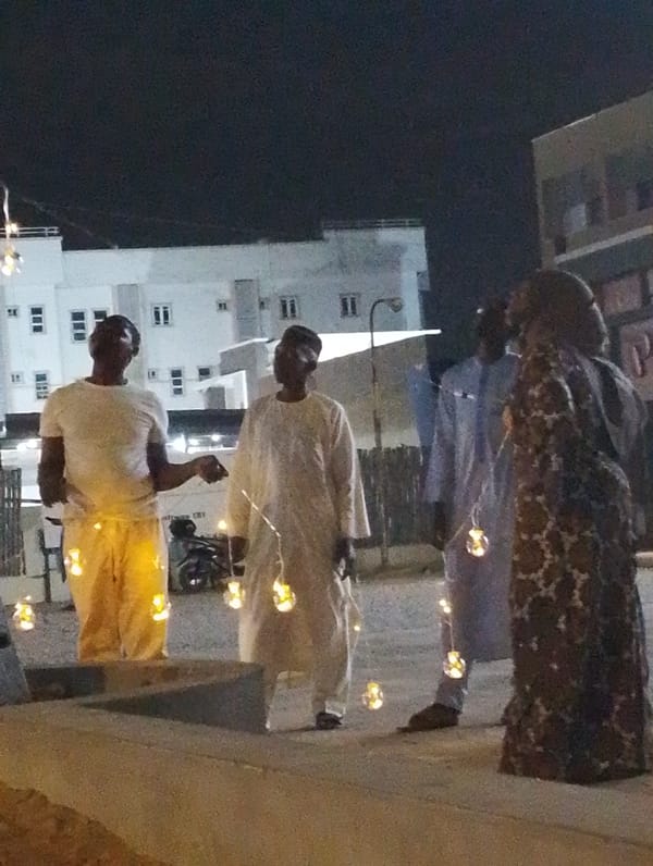 Nighttime gathering of people in Gandu Albasa, Nigeria
