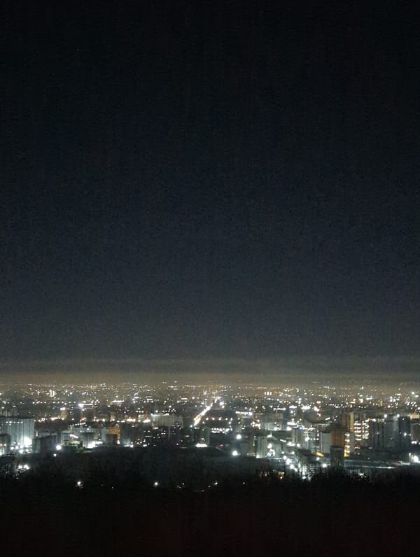 Nighttime aerial views of illuminated Bishkek cityscape captured