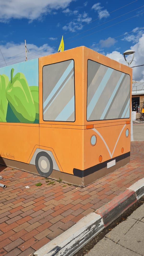 Woman explores and documents street scenes in Nahariyya, Israel