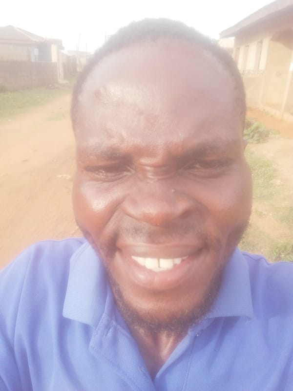 Man takes smiling selfies on sunny dirt road