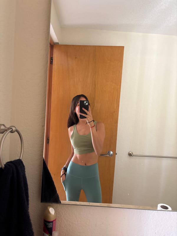 Person takes bathroom mirror selfie in athletic wear, Puebla
