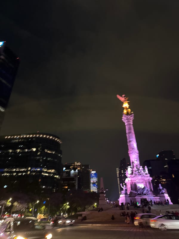 Angel of Independence monument lit purple in Mexico City