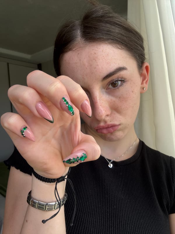 Woman displays elaborate green gemstone manicure in Bulgaria