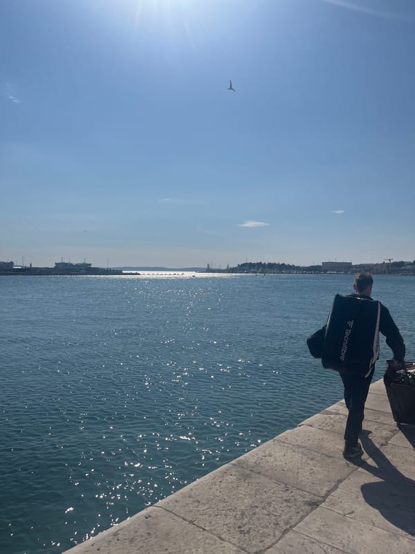 Tourist observes Adriatic Sea from Split waterfront walkway
