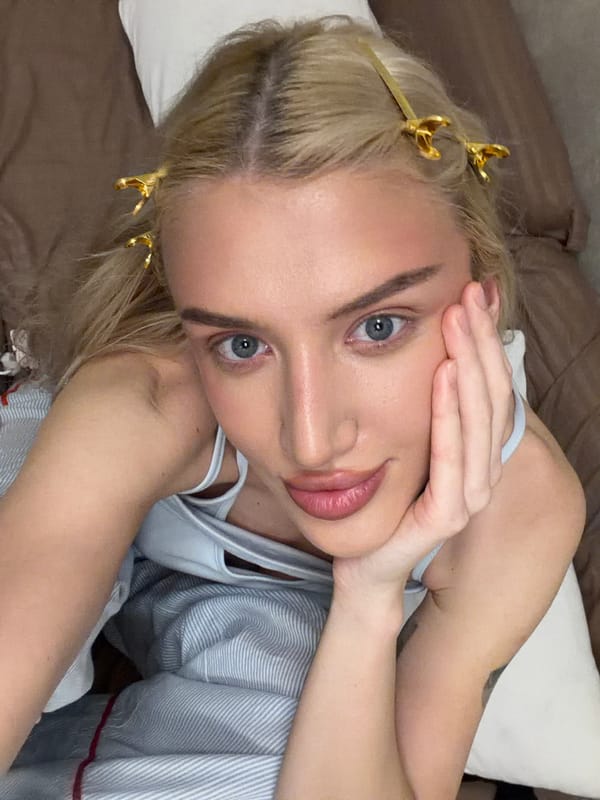 Woman with skincare patches rests on furniture in Belgrade