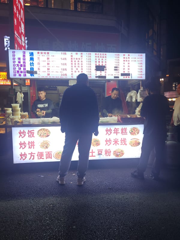 Night street food vendor serves customers in Jiangning District