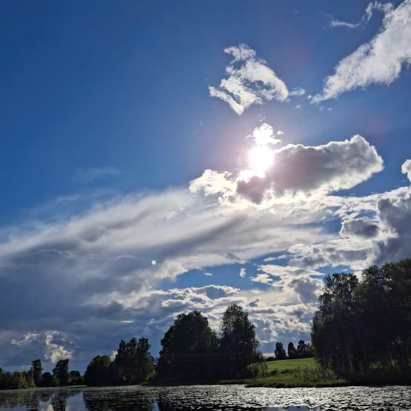 Still Norwegian lake mirrors dramatic summer cloudscape