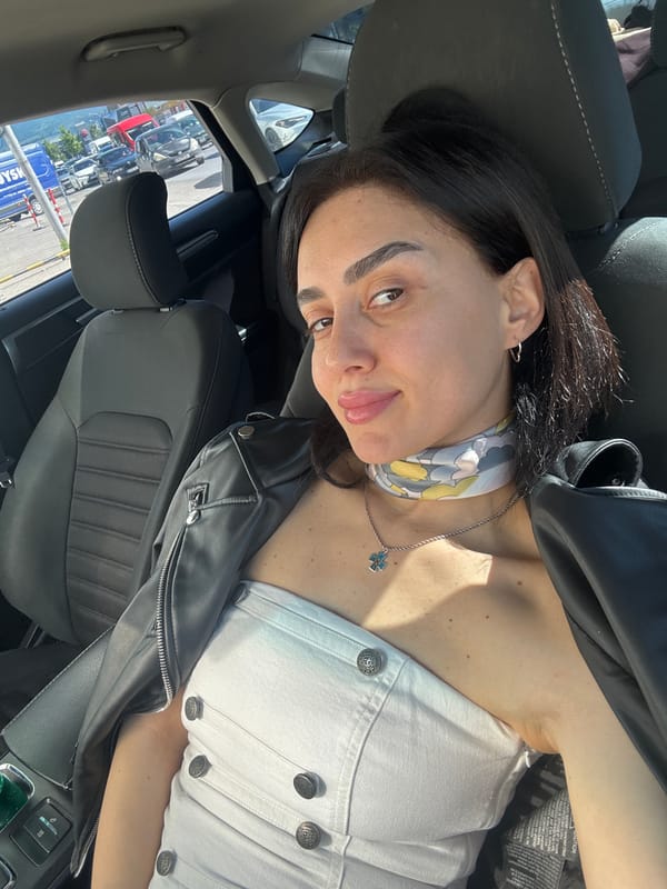 Woman takes selfie in car in Tbilisi, Georgia