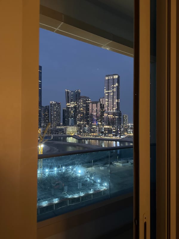 Resident watches twilight cityscape from Abu Dhabi high-rise balcony