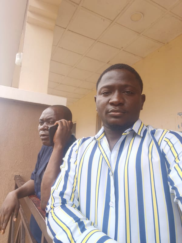 Two men photographed on balcony in Akwanga, Nigeria