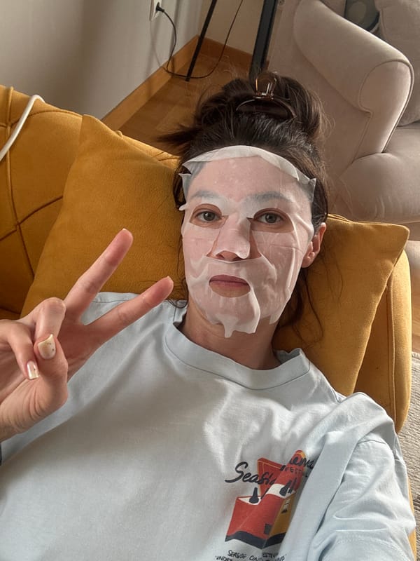 Woman enjoys skincare routine on couch in Podgorica