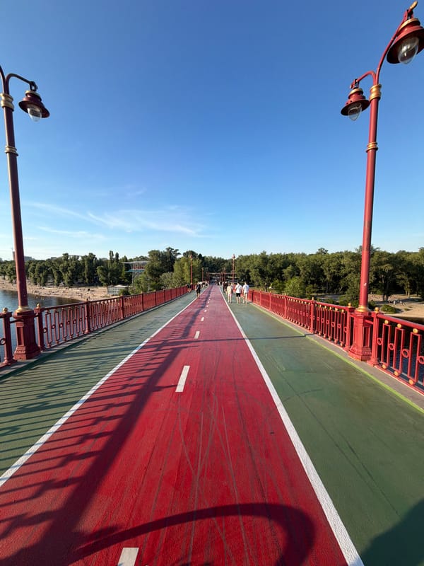 Sunny afternoon on Kyiv's pedestrian bridge over the Dnipro