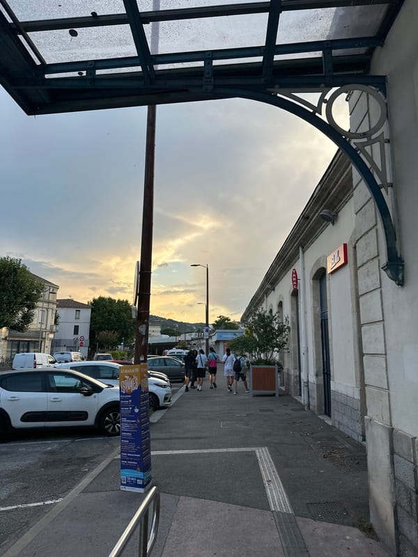 Evening at Alès station, trains parked under a dramatic sunset sky