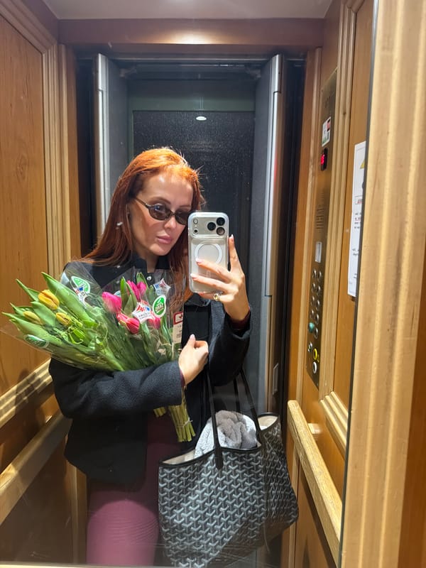Person takes elevator selfie with tulips in Paris