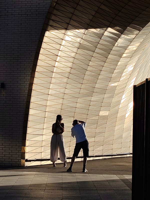 Two people silhouetted against lit Moscow architecture evening scene