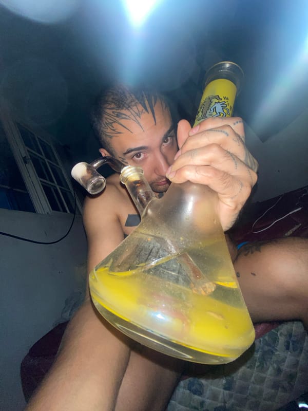 Person with tattoos uses bong in Buenos Aires residence