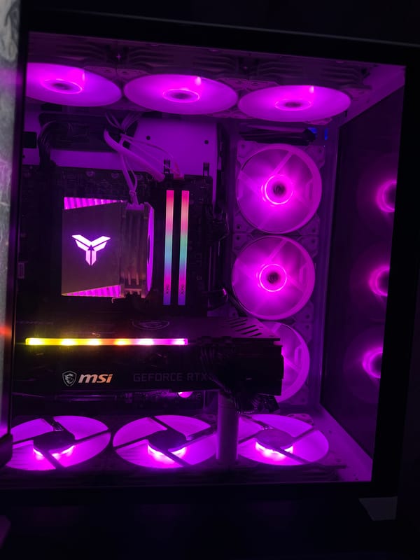 Inside a RGB gaming PC build, fans glowing in full color