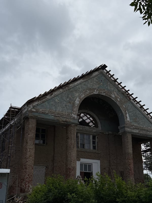 Soviet-era town in slow renovation, war memorials and wooden houses