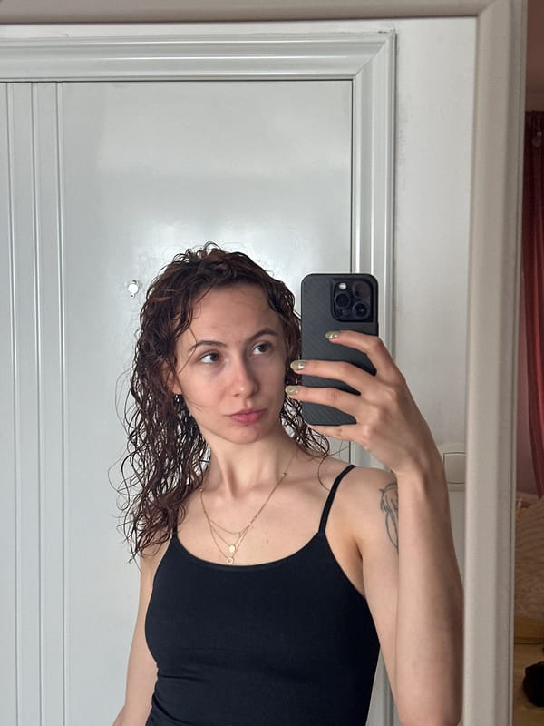 Woman photographs herself in Novi Sad apartment morning scene