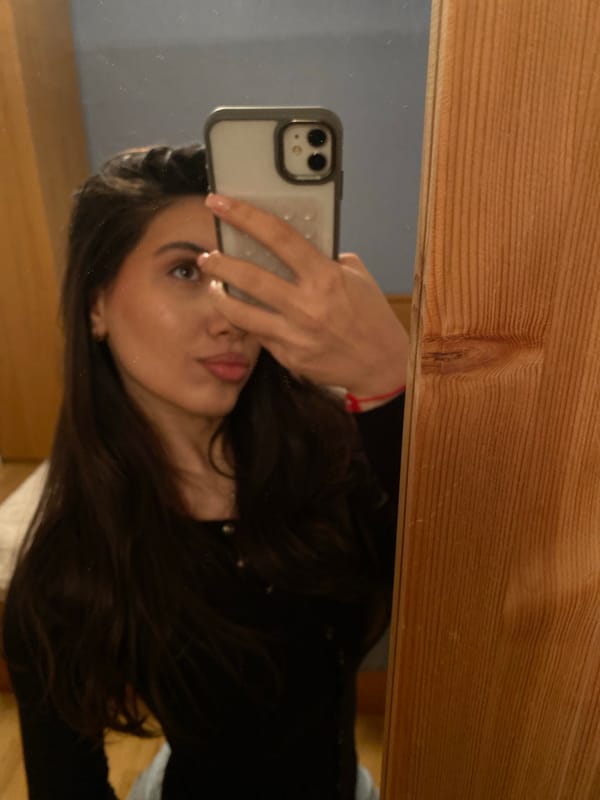 Woman takes mirror selfie in Björklinge, Sweden