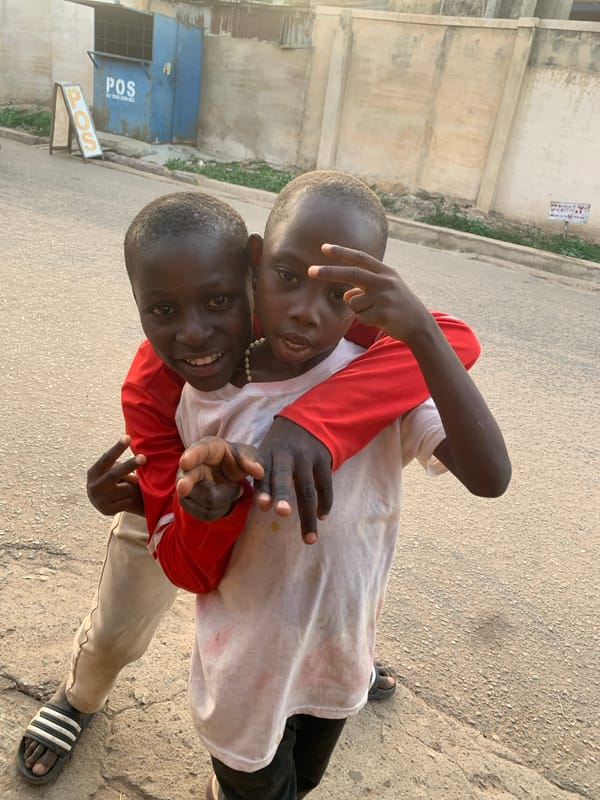 Boys playing, woman cooking captured in Jos, Nigeria
